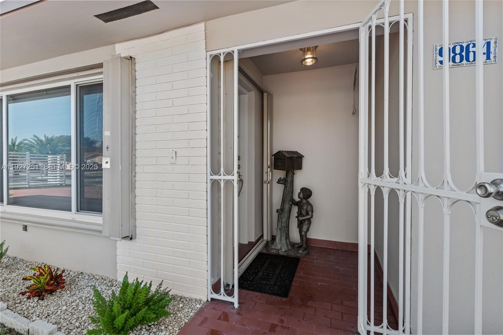 9864 Southwest 26th Terrace Miami, FL 33165 - Photo 5 of 40 a view of a entryway door of the house