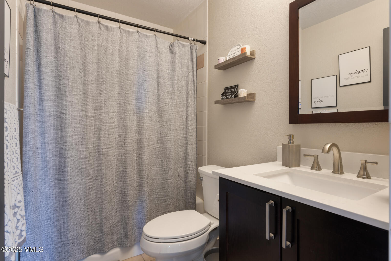 318 Mesa Drive Eagle, CO 81631 - Photo 25 of 44 a bathroom with a sink a toilet and shower curtain