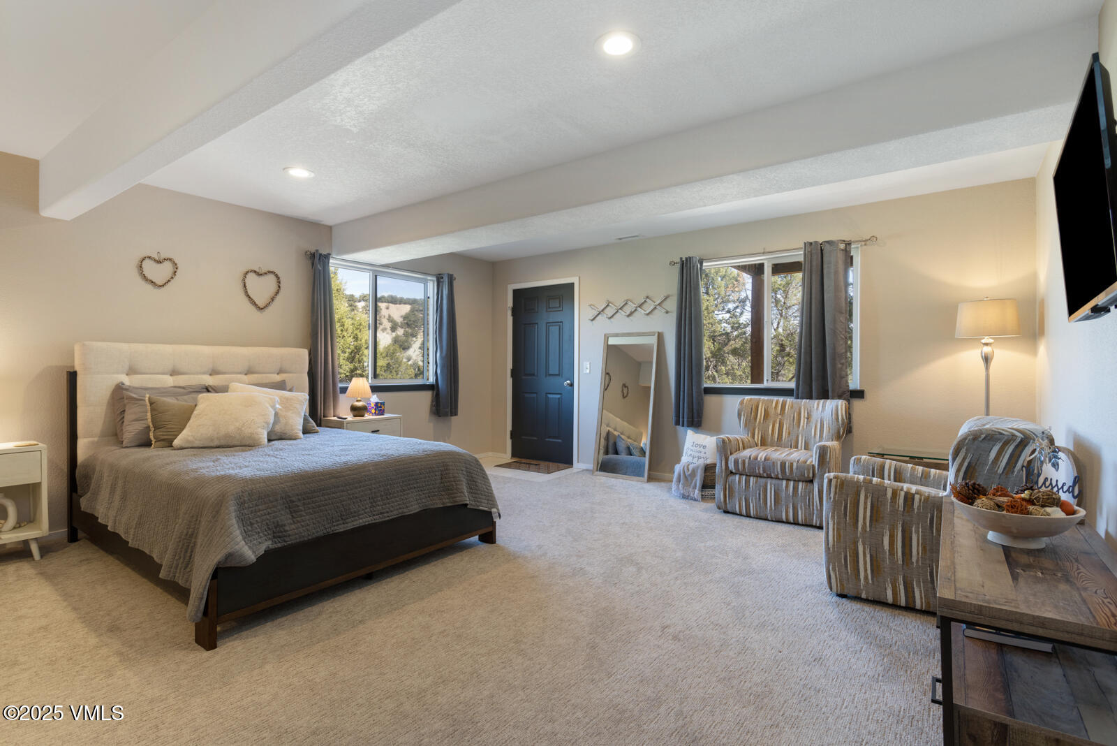 318 Mesa Drive Eagle, CO 81631 - Photo 27 of 44 a spacious bedroom with a bed and a lamp