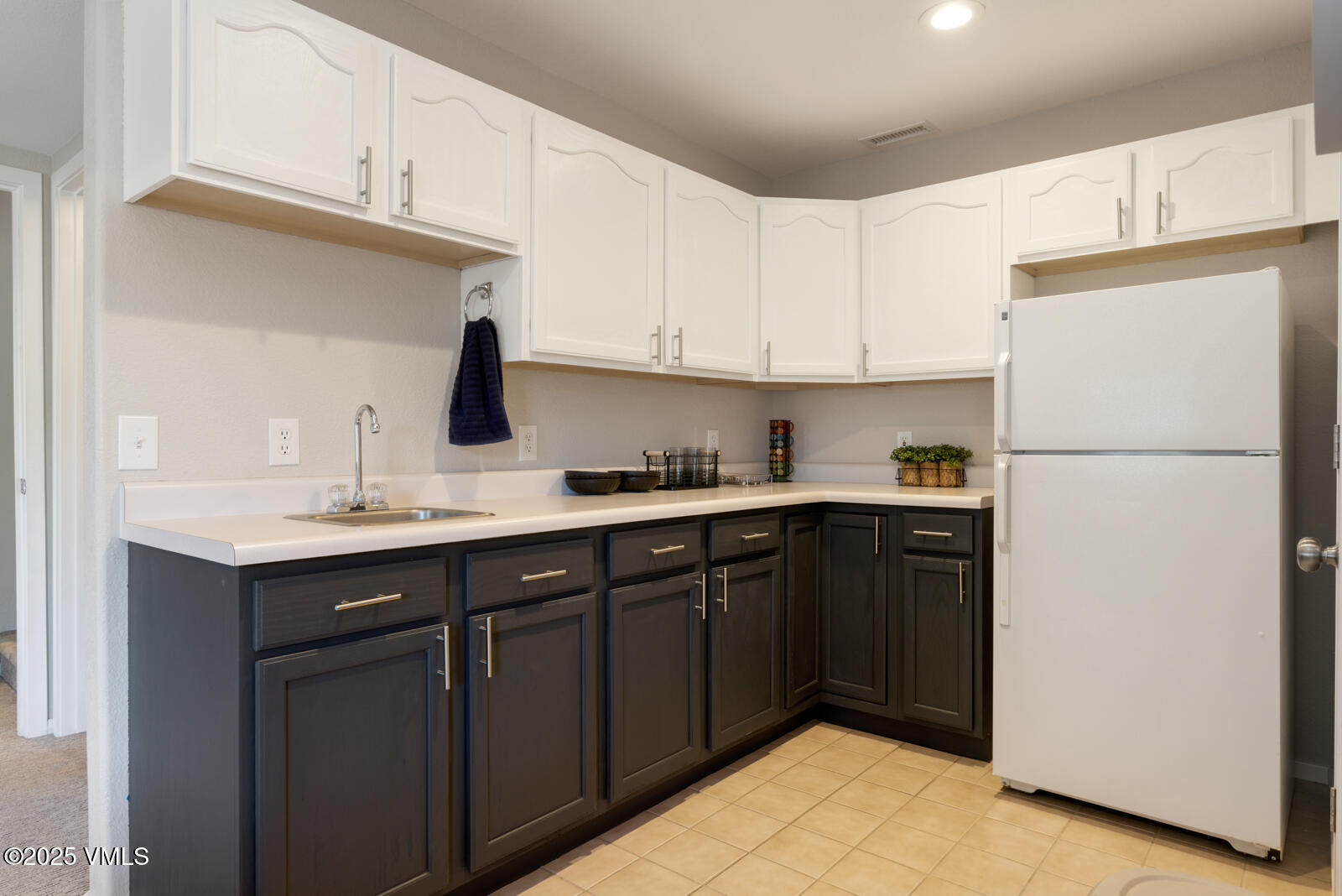 318 Mesa Drive Eagle, CO 81631 - Photo 29 of 44 a kitchen with a sink a refrigerator and cabinets