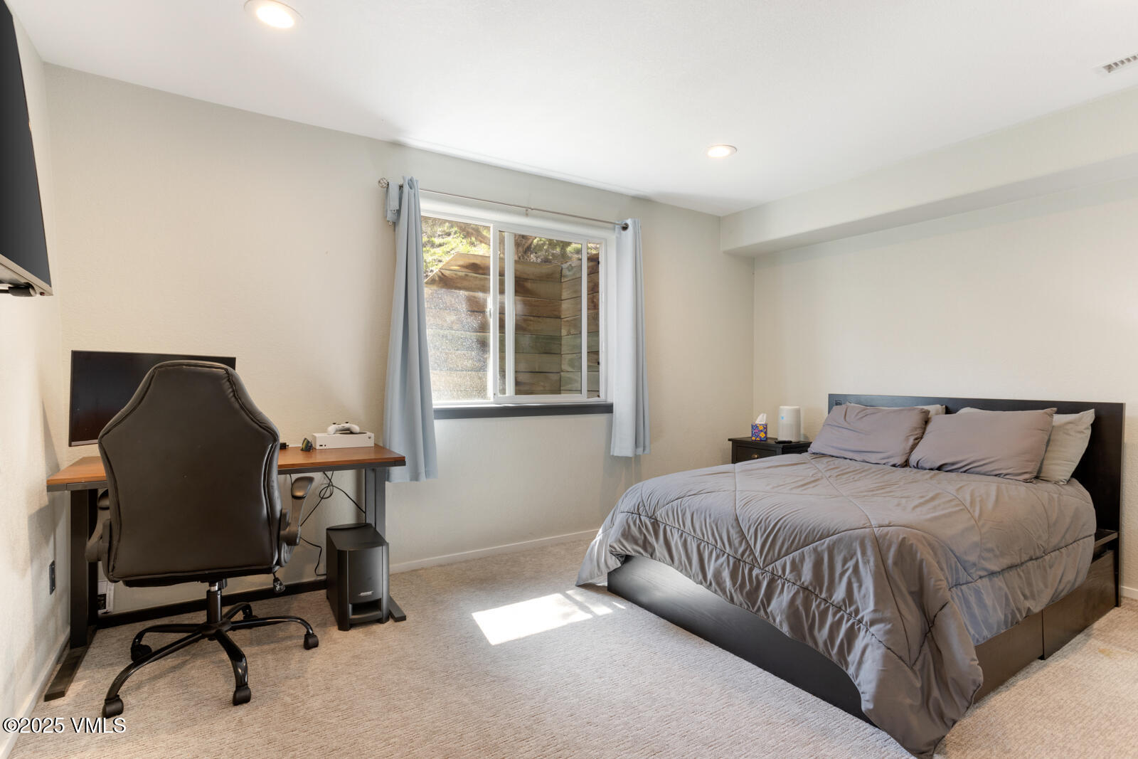 318 Mesa Drive Eagle, CO 81631 - Photo 34 of 44 a bedroom with a large bed and a desk