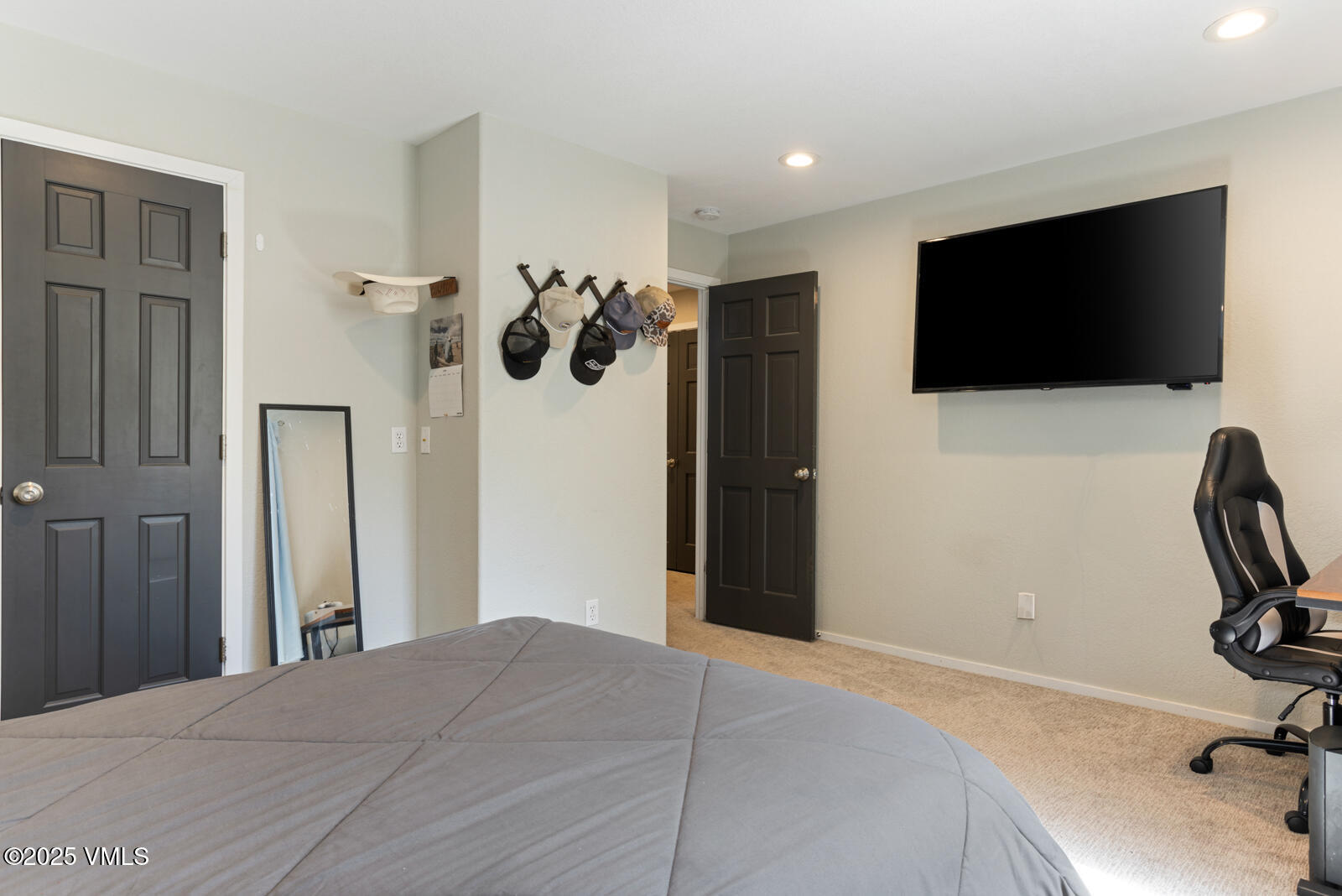 318 Mesa Drive Eagle, CO 81631 - Photo 35 of 44 a bedroom with a bed and a flat screen tv