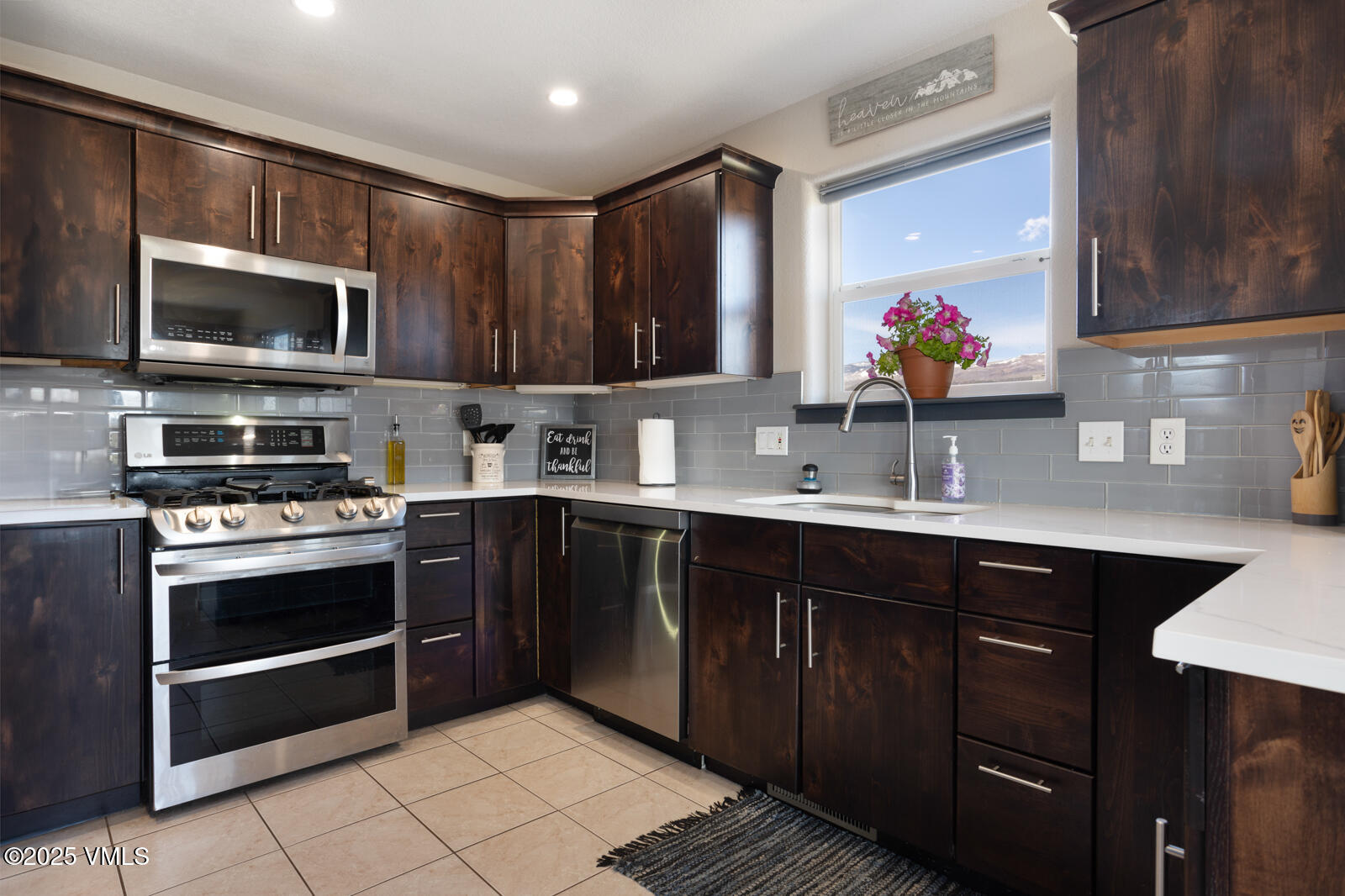 318 Mesa Drive Eagle, CO 81631 - Photo 7 of 44 a kitchen with stainless steel appliances a sink stove and microwave