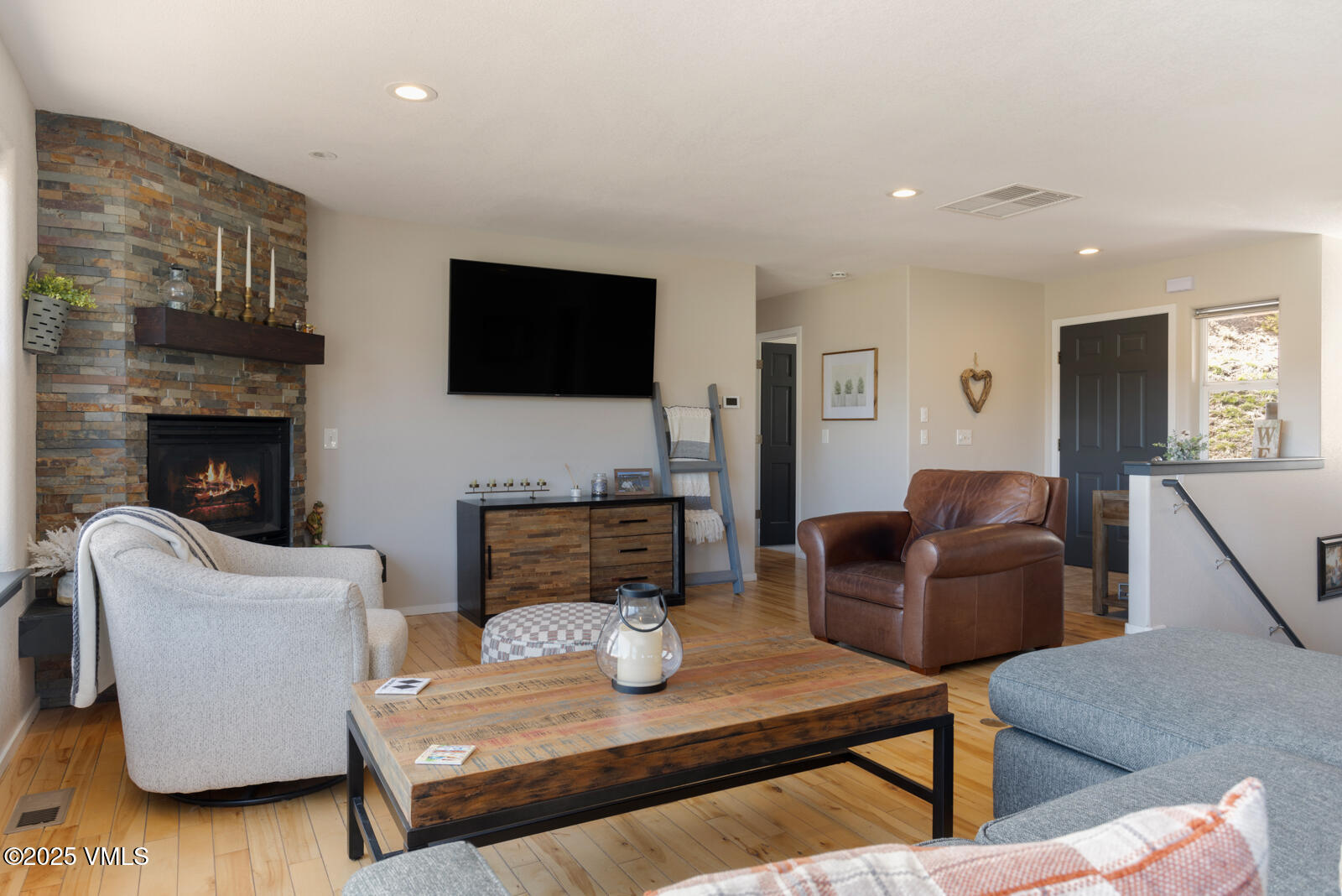 318 Mesa Drive Eagle, CO 81631 - Photo 9 of 44 a living room with furniture a flat screen tv and a fireplace