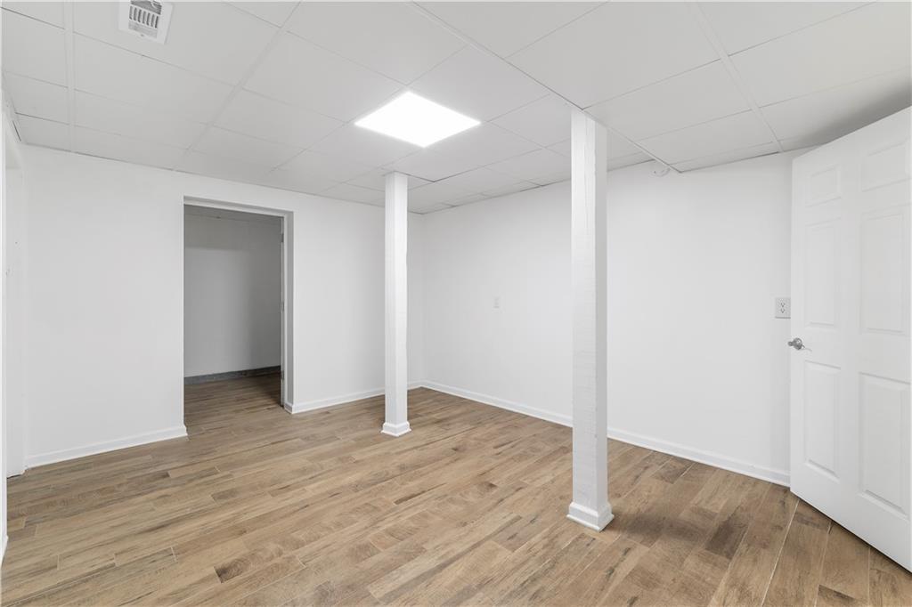 8965 Laurel Way Alpharetta, GA 30022 - Photo 53 of 79 an empty room with wooden floor