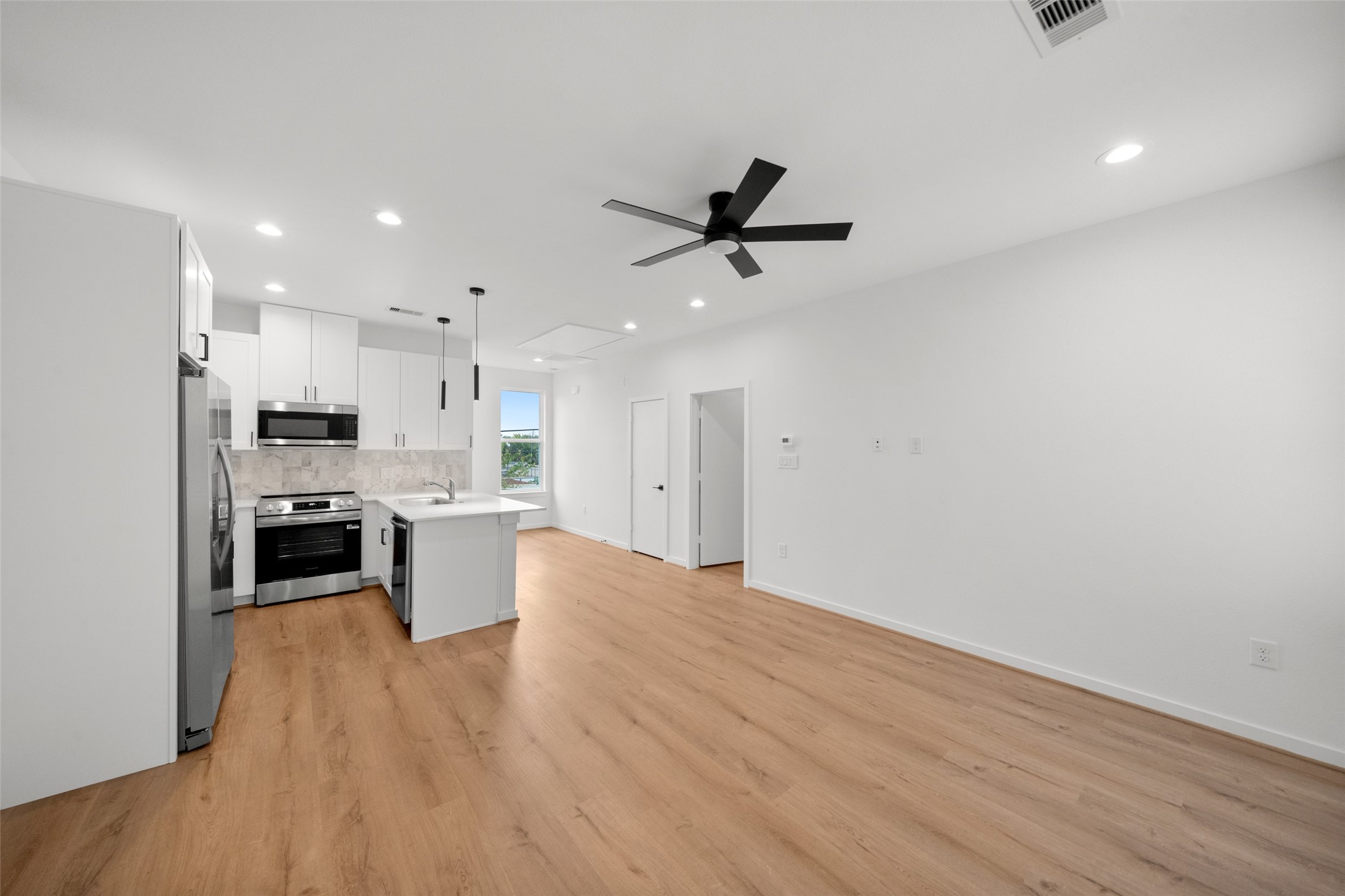 1408 Enid Street, Unit D Houston, TX 77009 - Photo 11 of 26 a view of kitchen with refrigerator microwave and stove