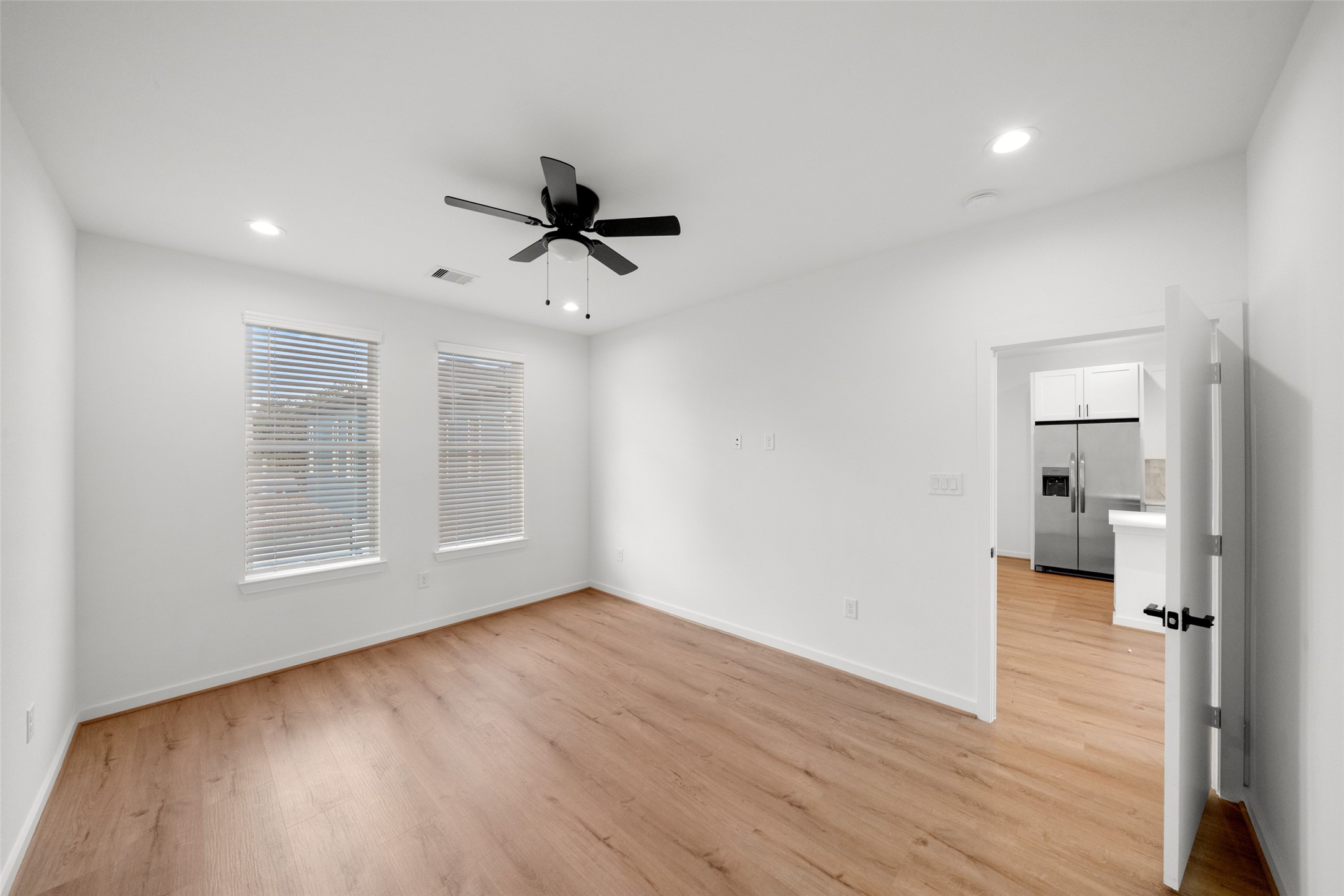 1408 Enid Street, Unit D Houston, TX 77009 - Photo 13 of 26 a view of empty room with wooden floor and window