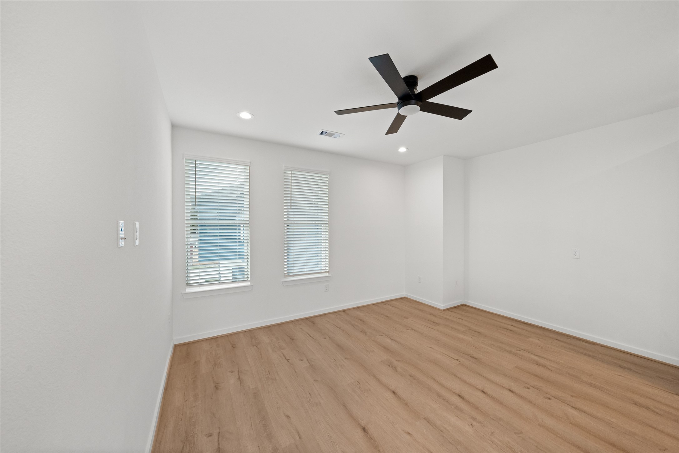 1408 Enid Street, Unit D Houston, TX 77009 - Photo 7 of 26 a view of empty room with wooden floor and ceiling fan