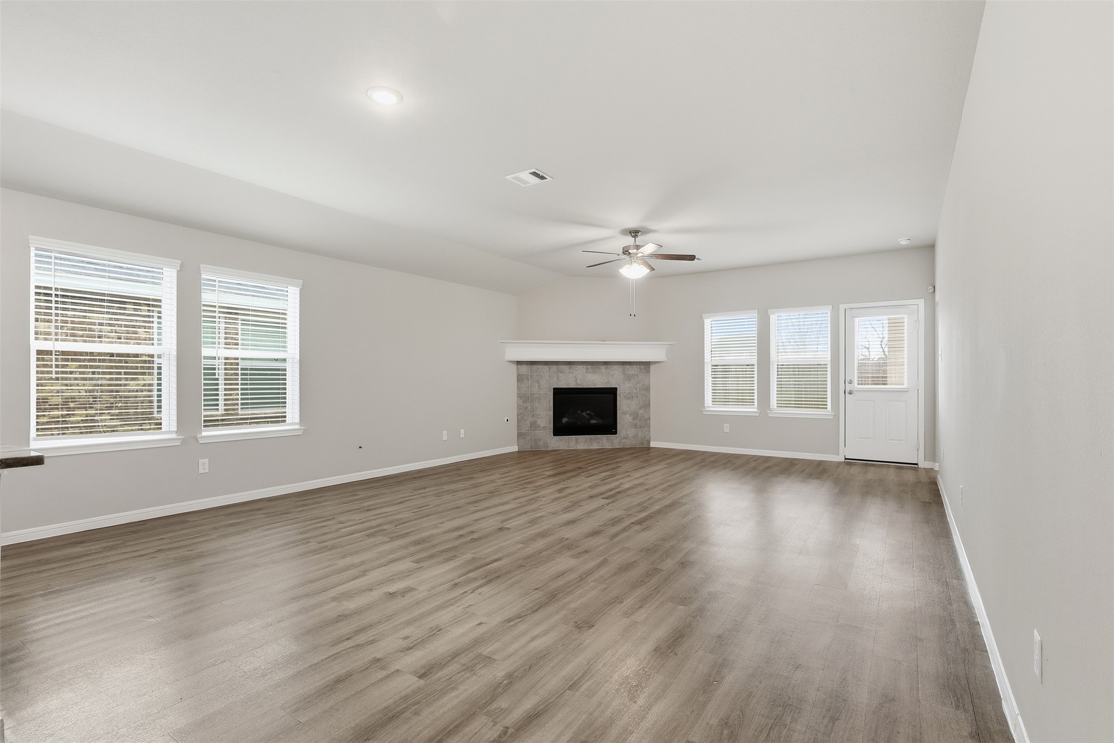3227 Falling Brk Drive Baytown, TX 77521 - Photo 11 of 28 an empty room with wooden floor and windows