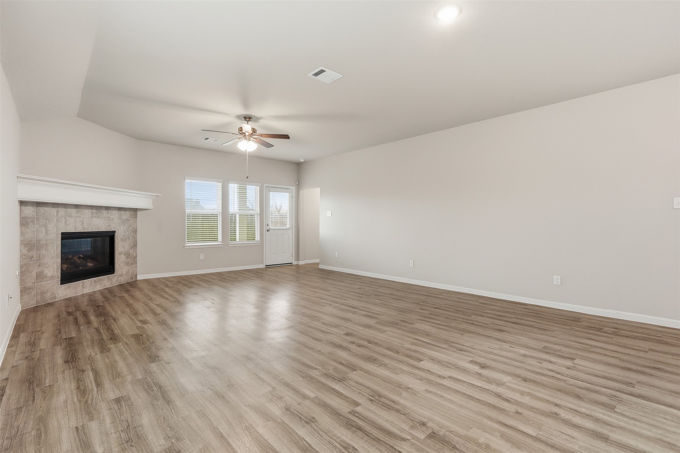 3227 Falling Brk Drive Baytown, TX 77521 - Photo 12 of 28 an empty room with wooden floor and windows