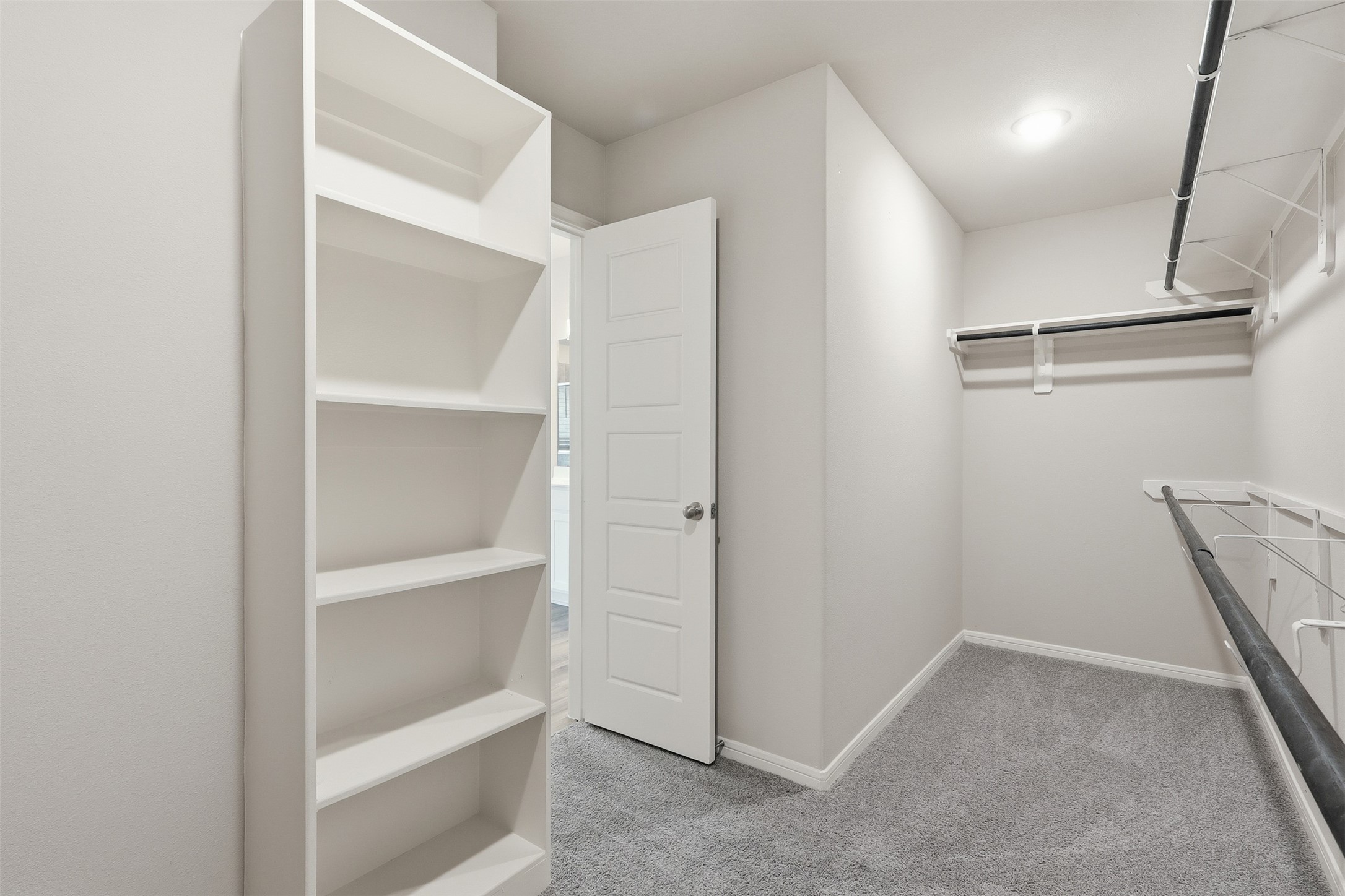 3227 Falling Brk Drive Baytown, TX 77521 - Photo 19 of 28 a view of walk in closet with empty racks