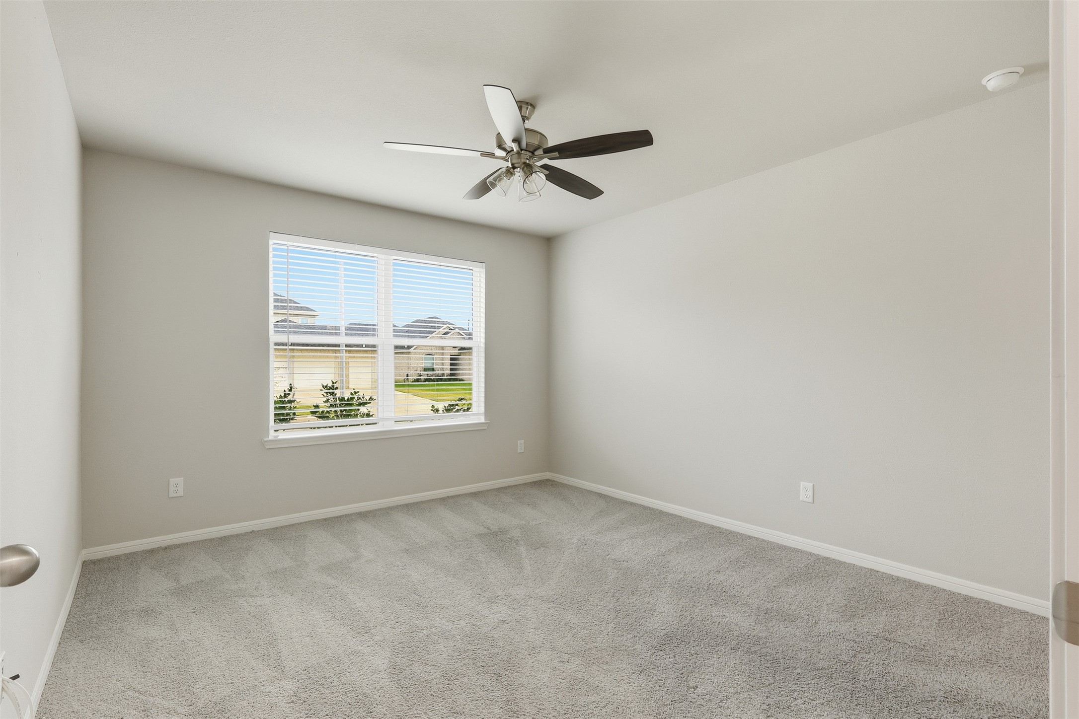 3227 Falling Brk Drive Baytown, TX 77521 - Photo 5 of 28 an empty room with windows and fan