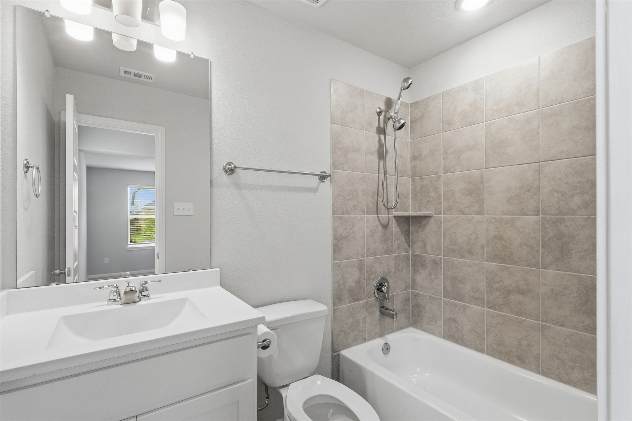 3227 Falling Brk Drive Baytown, TX 77521 - Photo 7 of 28 a bathroom with a sink a toilet a mirror and shower