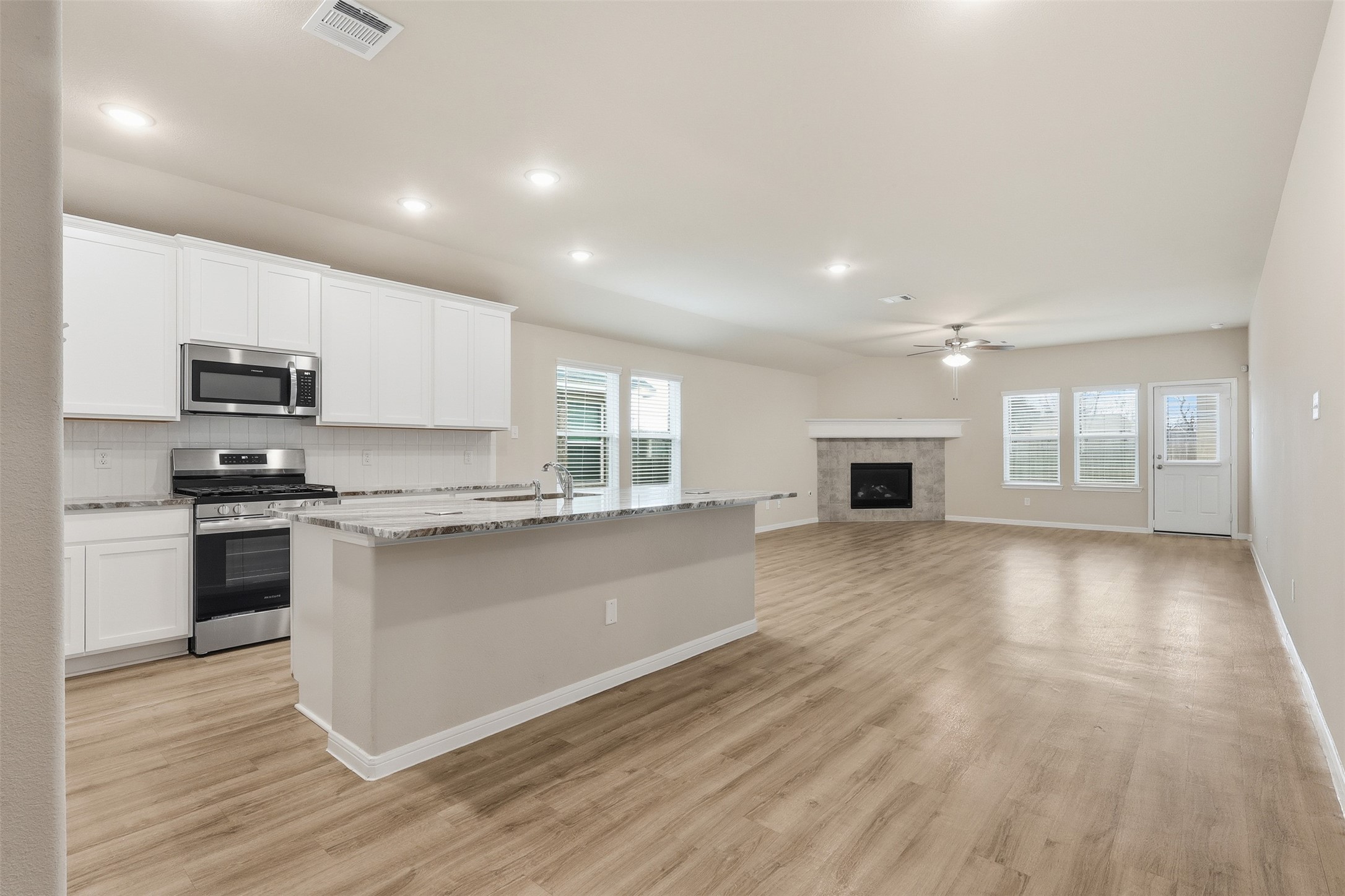 3227 Falling Brk Drive Baytown, TX 77521 - Photo 8 of 28 a kitchen with granite countertop a stove a sink and a refrigerator