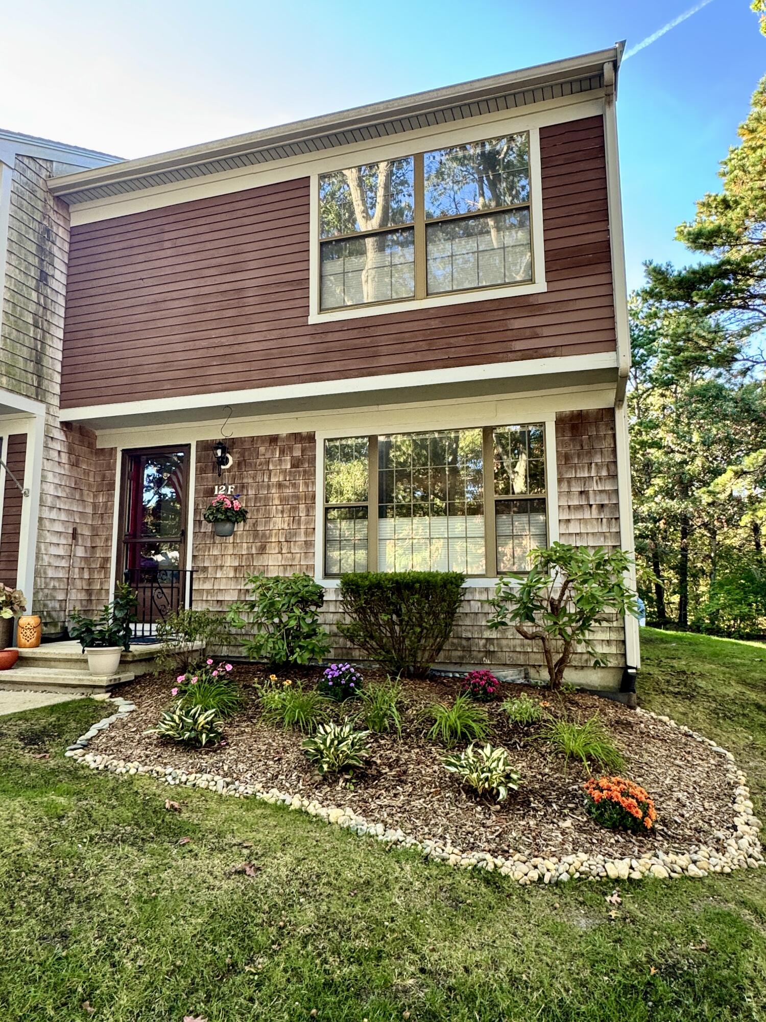 a front view of a house with garden and outdoor seating
