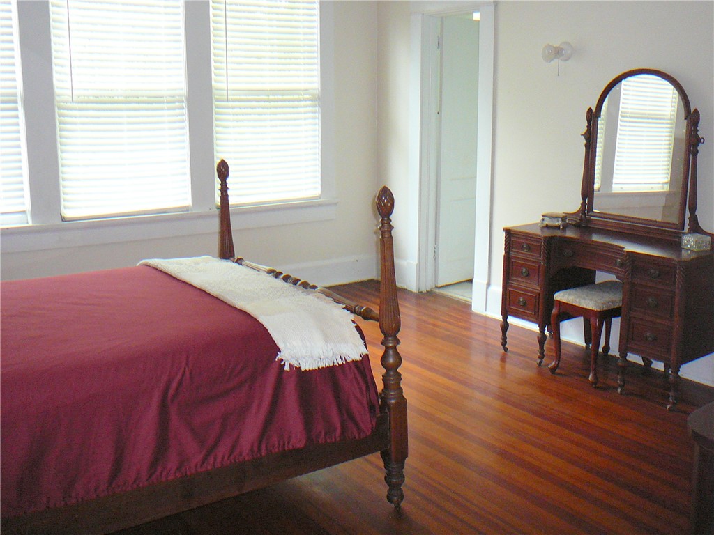 411 Central Avenue Anderson, SC 29625 - Photo 18 of 23 This spacious room features rich wood flooring, ample natural light, and classic architectural details.