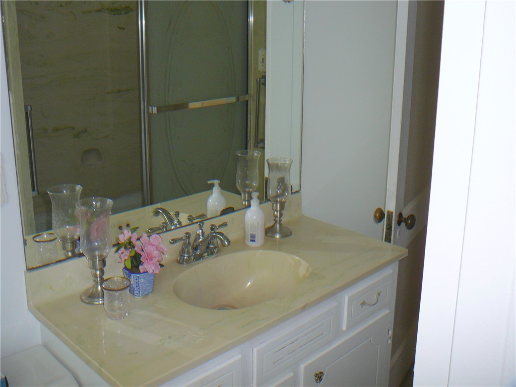 411 Central Avenue Anderson, SC 29625 - Photo 20 of 23 This bathroom features a sleek vanity with a spacious countertop and an integrated sink.