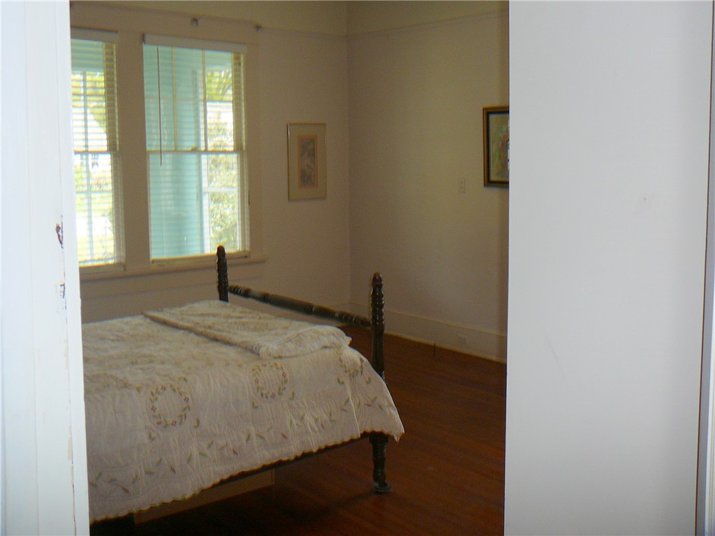 411 Central Avenue Anderson, SC 29625 - Photo 21 of 23 This spacious room offers ample natural light and rich wood flooring.