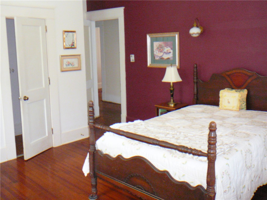 411 Central Avenue Anderson, SC 29625 - Photo 22 of 23 This cozy bedroom features polished wood floors and classic architectural details.