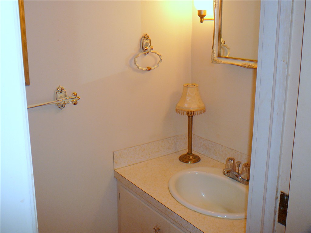 411 Central Avenue Anderson, SC 29625 - Photo 23 of 23 This bathroom features a classic vanity with a sink and mirror.