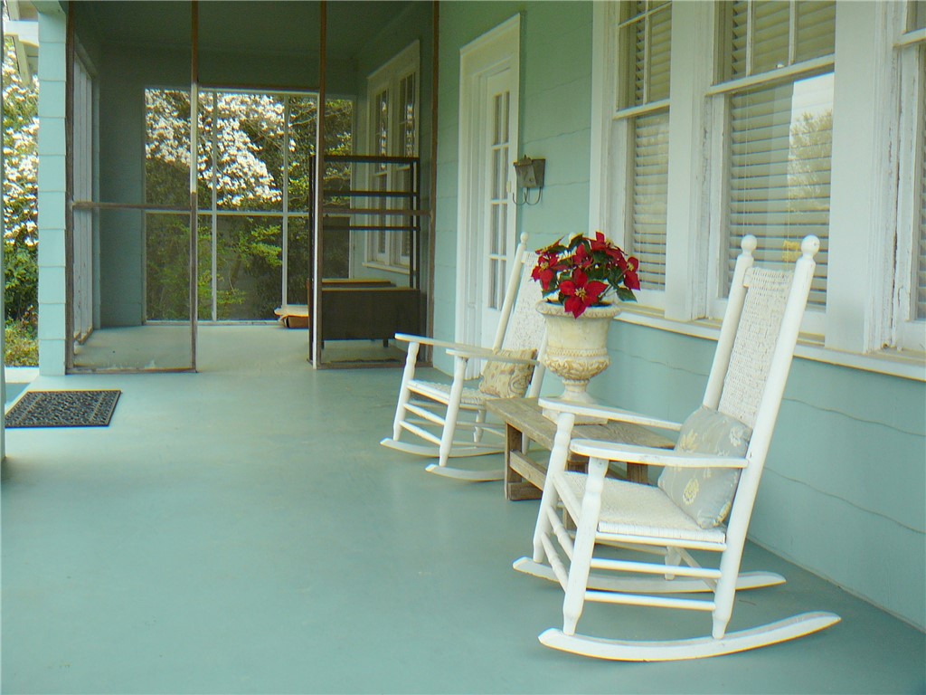 411 Central Avenue Anderson, SC 29625 - Photo 5 of 23 Relax on this charming covered porch, perfect for enjoying peaceful moments outdoors.