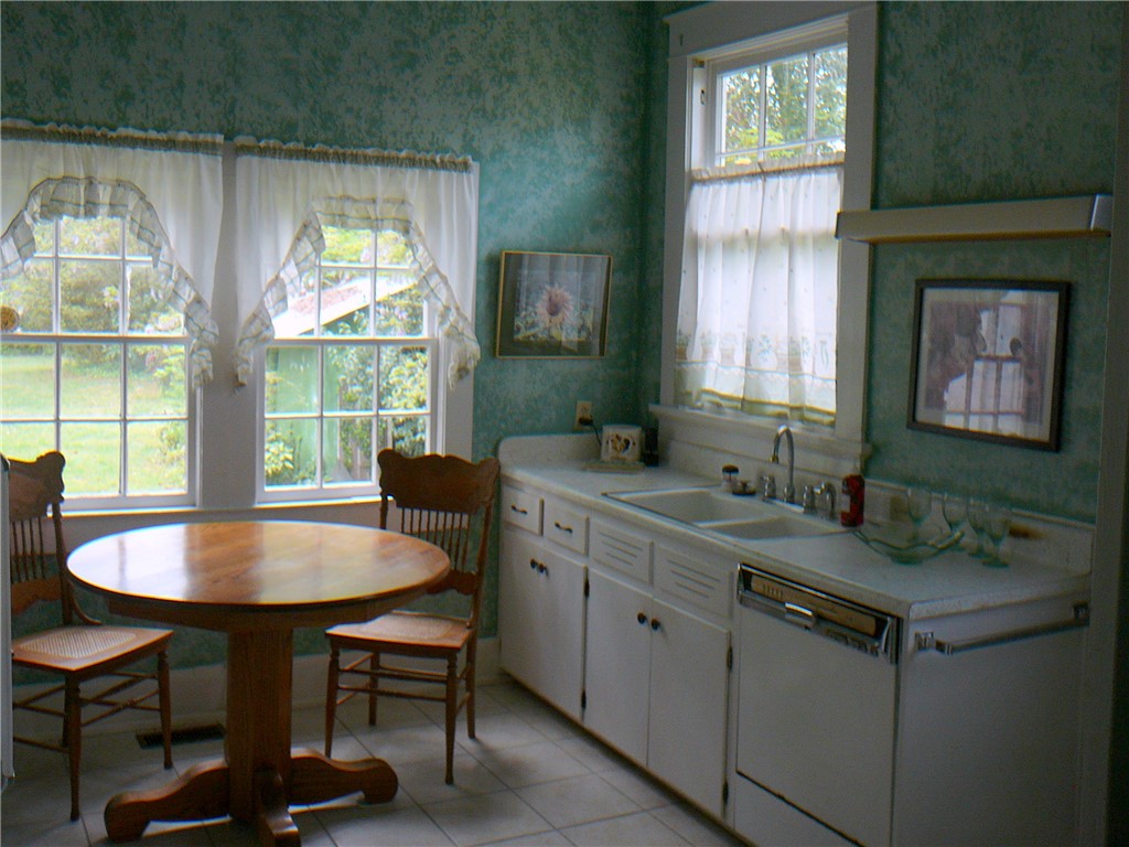 411 Central Avenue Anderson, SC 29625 - Photo 10 of 23 This cozy kitchen features abundant natural light and functional appliances for comfortable daily living.
