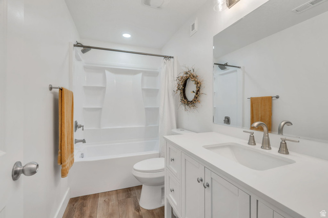 2664 West Maple Street Mapleton, UT 84664 - Photo 27 of 49 Bathroom featuring a white vanity with an integrated sink, brushed nickel hardware, and a large mirror