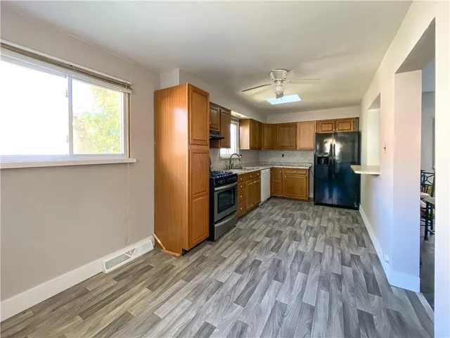 a kitchen with stainless steel appliances a stove top oven and refrigerator