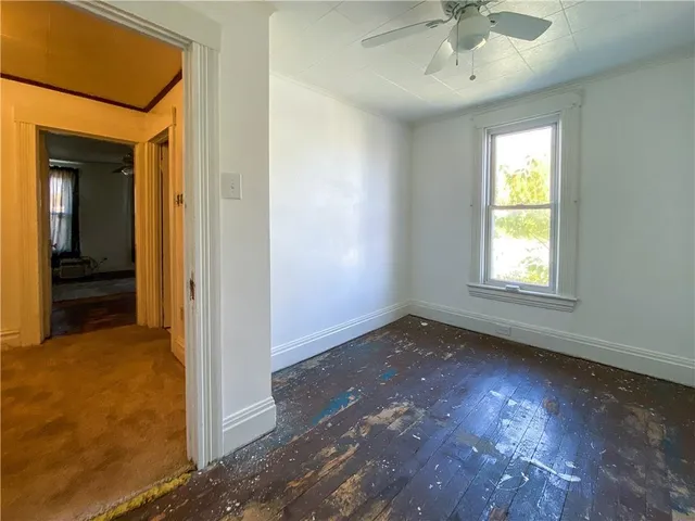 wooden floor in an empty room with a window