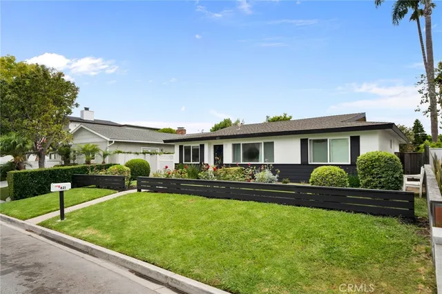 a front view of a house with a yard table and chairs