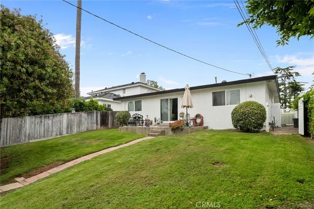 a view of a house with backyard and sitting area