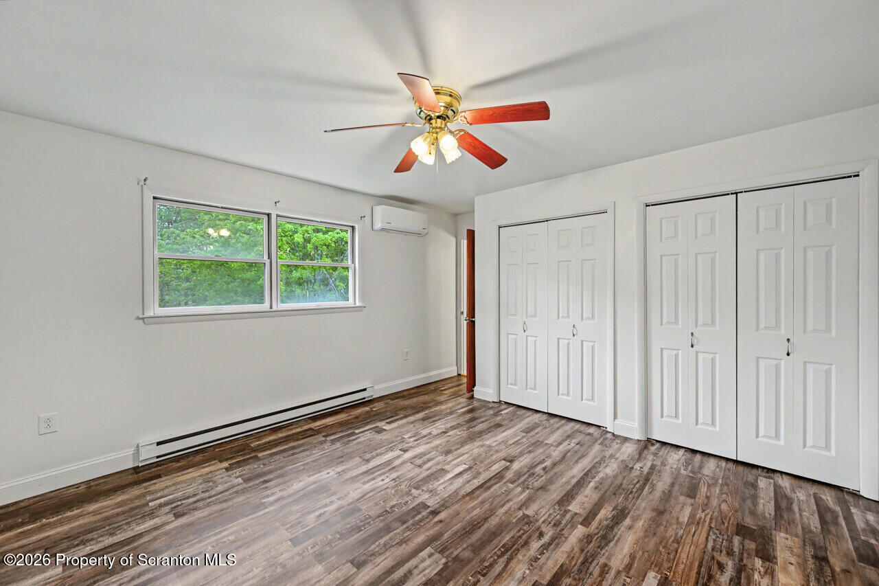 211 Buckingham Street Moscow, PA 18444 - Photo 43 of 83 a view of an empty room with a window and wooden floor
