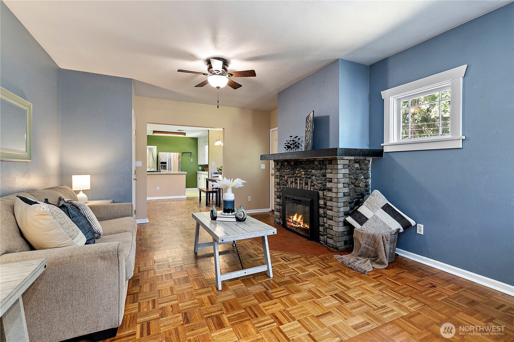 9880 Fredrickson Road Northwest Bremerton, WA 98311 - Photo 5 of 28 a living room with furniture a fireplace and a table