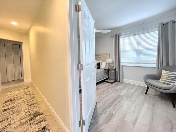 a view of a bedroom with furniture and windows