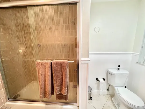 a bathroom with a toilet and a shower