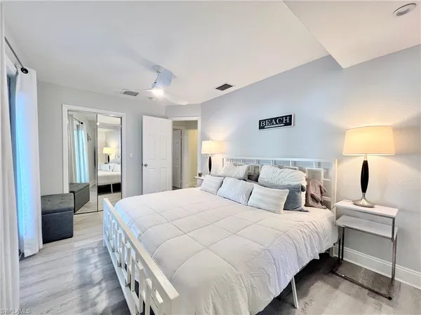 a bedroom with a bed and a lamp