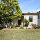 a view of a house with yard and tree s