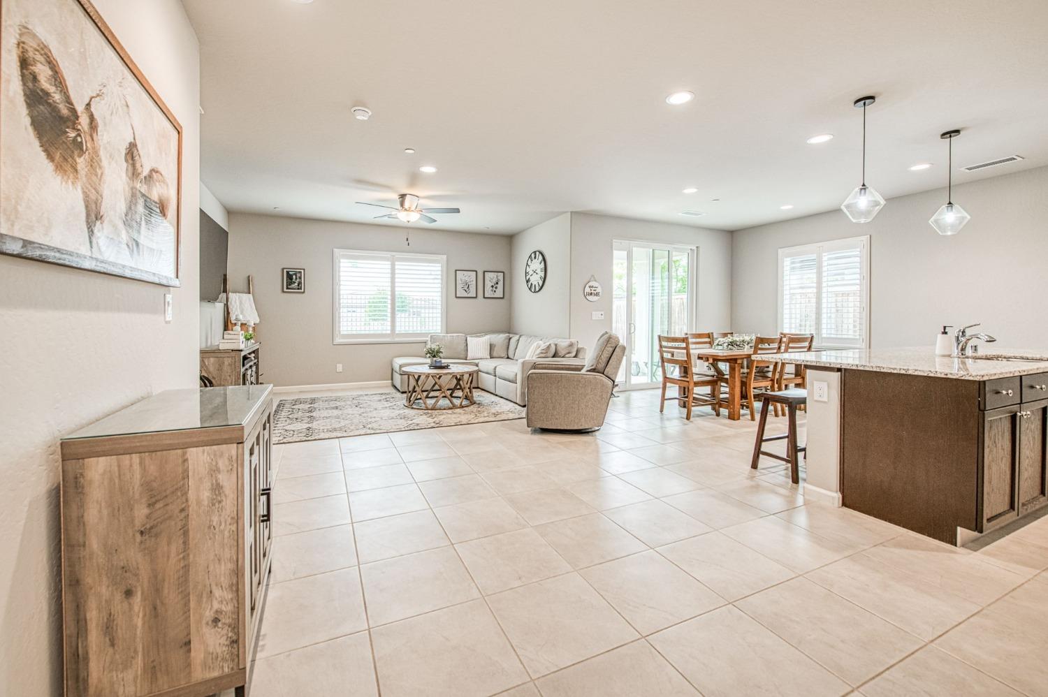 4722 Orchard Hills Road Madera, CA 93636 - Photo 9 of 28 a living room with furniture a wooden floor and kitchen view
