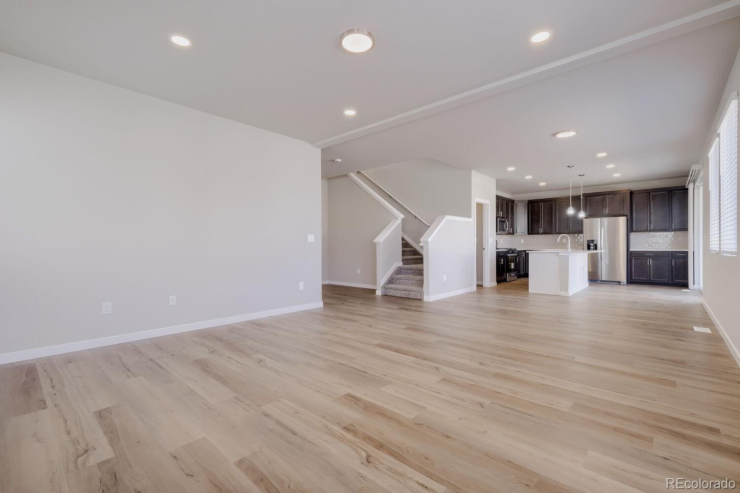 471 Atchison Way Calhan, CO 80808 - Photo 7 of 31 a view of empty room with wooden floor