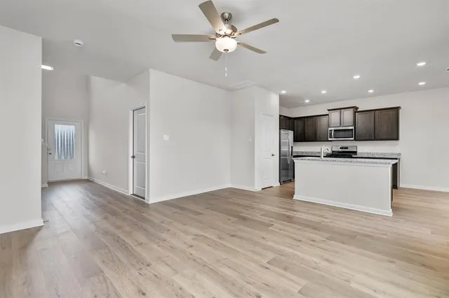a view of kitchen with refrigerator stove microwave and cabinets