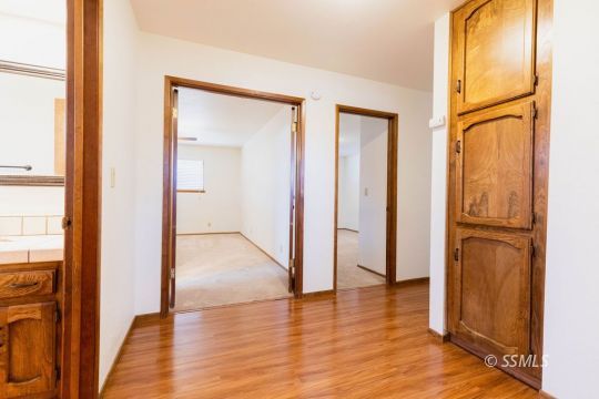 321 South Locust Street Ridgecrest, CA 93555 - Photo 15 of 30 an empty room with wooden floor and a window