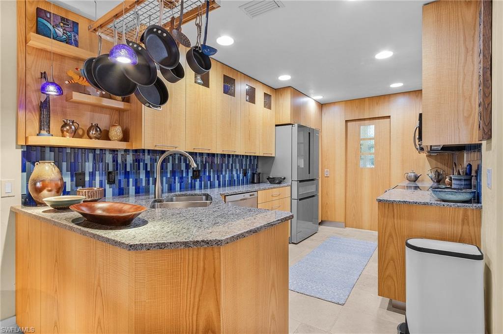 5677 Cove Circle Naples, FL 34119 - Photo 1 of 26 a kitchen with a sink and cabinets