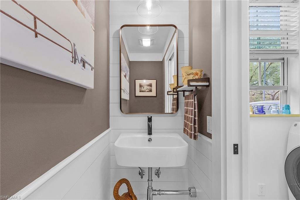 5677 Cove Circle Naples, FL 34119 - Photo 11 of 26 a bathroom with a sink and a mirror