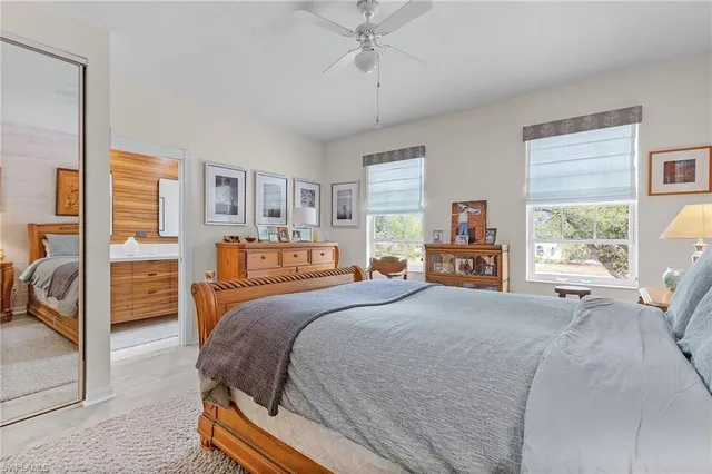 a bedroom with a large bed and a large window