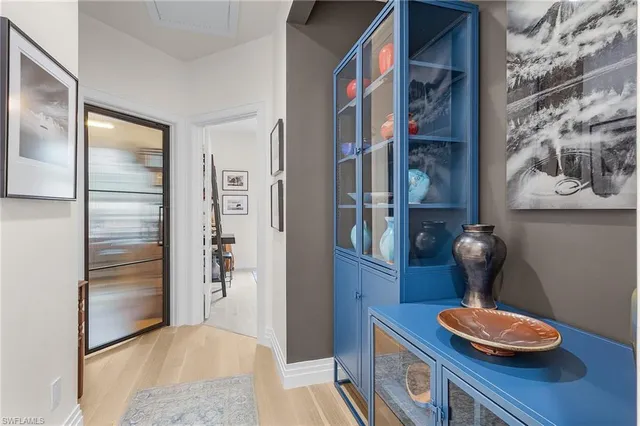 a dining room with stainless steel appliances furniture and wooden floor