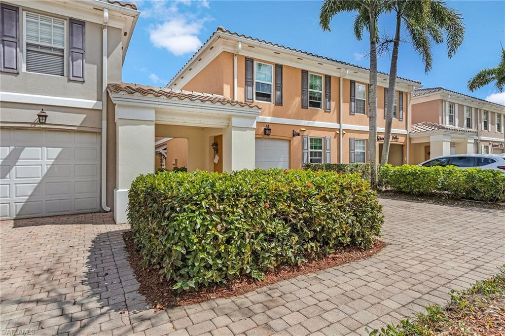 5677 Cove Circle Naples, FL 34119 - Photo 3 of 26 a view of a house with a garden