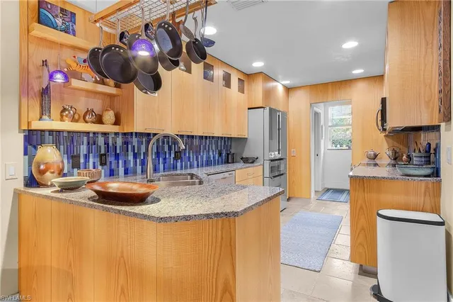 a kitchen with a sink a stove and cabinets
