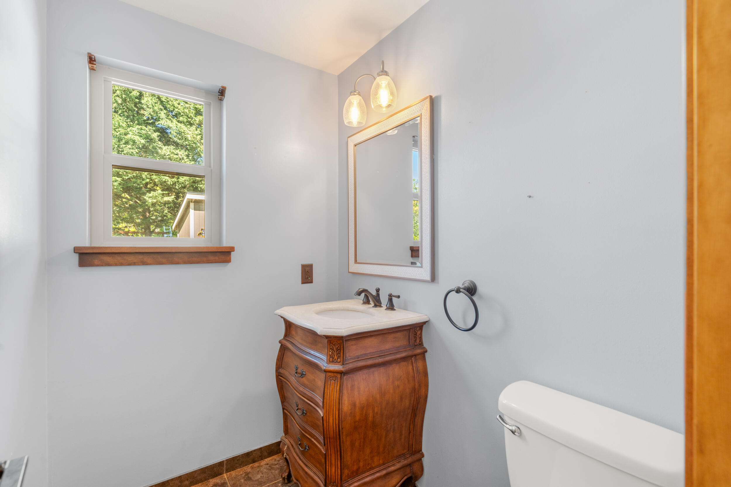 3583 Ross Lane Central Point, OR 97502 - Photo 11 of 52 a bathroom with a granite countertop sink a toilet and a mirror