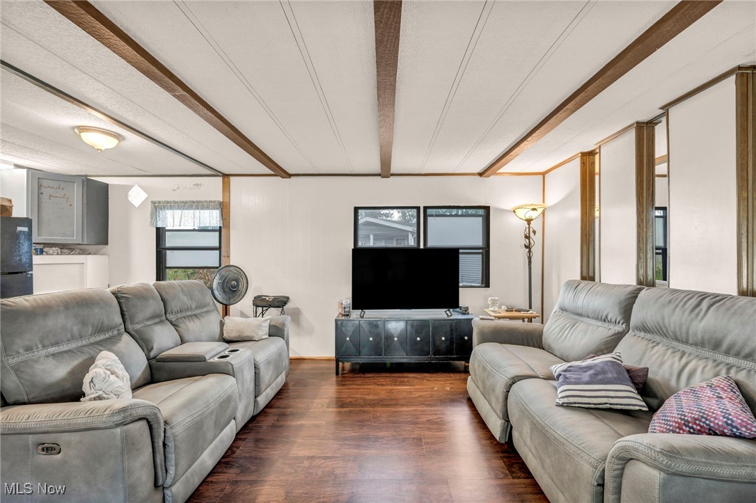 35157 Center Ridge Road, Unit 126 North Ridgeville, OH 44039 - Photo 32 of 50 Living area featuring beam ceiling and dark wood finished floors