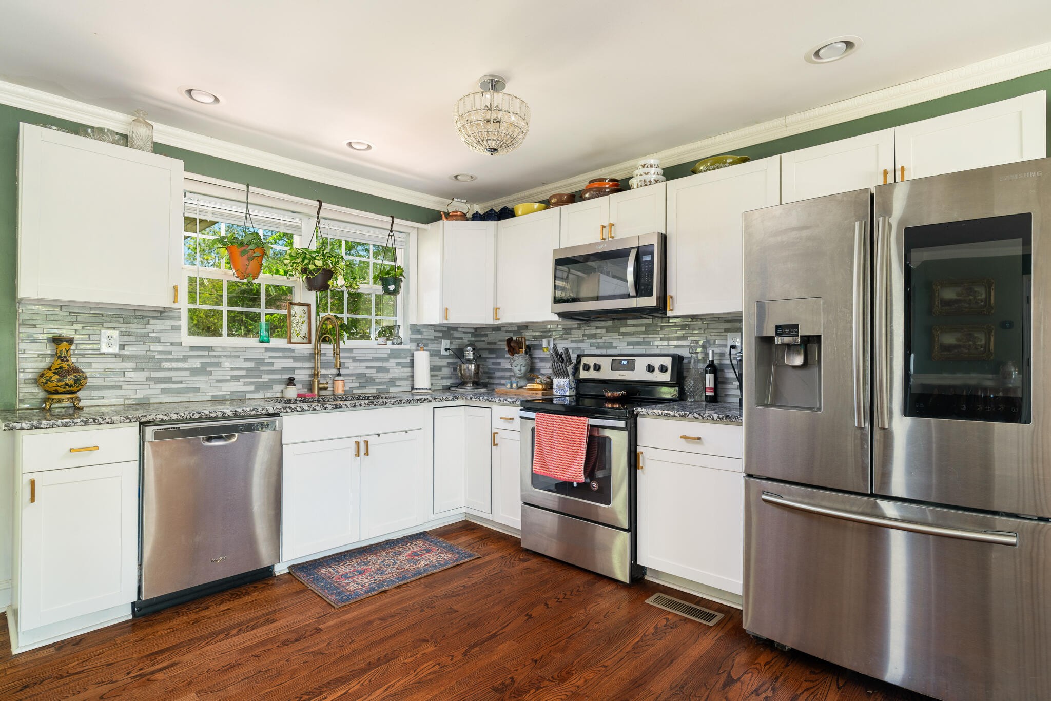 912 Barnabas Street Athens, TN 37303 - Photo 8 of 32 a kitchen with stainless steel appliances granite countertop a refrigerator a stove top oven a sink and dishwasher with wooden floor